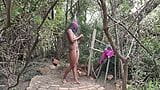 Donkere getatoeëerde Desi -slet die een douche neemt in het bos in een naaktresort snapshot 2
