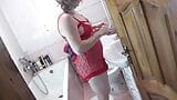 MILF sexy blonde wakes up in morning, pisses, brushes teeth, gets dressed. Fetish peignoir, skirt, stockings, high heels snapshot 8