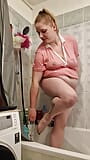 A chubby student girl takes a shower in a pink T-Shirt snapshot 13