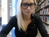 Leuk blond universiteitsmeisje dat in de bibliotheek knippert snapshot 11