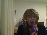 horny MILF tranny in front of the camera simulates a Blowjob while playing with a vibrator snapshot 6