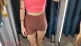 A girl with a perfect figure shows her breasts in a fitting room snapshot 3