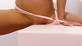 Beauty in pink panties humps pussy against the table corner. snapshot 10