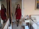 Nice looking broad models her little red number. snapshot 1