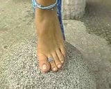 Slavegirl shows off her bare feet. snapshot 1