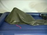 Woman struggling in a green latex bag snapshot 4