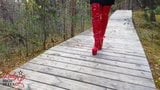 Lady L sexy walking with extreme red boots in forest. snapshot 10