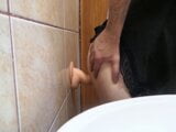 Playing with a curved dildo against the wall snapshot 2