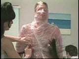 Guy getting wrapped in plastic snapshot 16