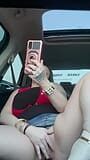 Horny slut watching porn using dildo In car while driving down the road snapshot 9