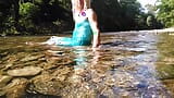 Sexy t-girl swimming in mountain river and wetting teal summer dress ... snapshot 6