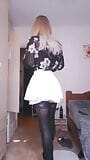 Shemale posing in a white skirt, stockings and high heels snapshot 1