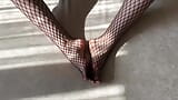 Girl in black fishnet pantyhose caresses her legs snapshot 4