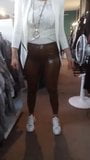 Wife in brown Latex Pants in her boutique snapshot 2