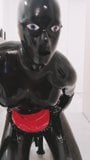 Rubber latex sissy with doll hood playing with anal dildo snapshot 12