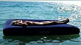 I watched on the beach how a naked girl with big tits was sunbathing on a mattress. Slow motion snapshot 1