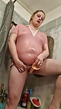 A chubby student girl takes a shower in a pink T-Shirt snapshot 10