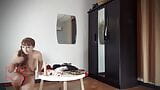 A naked lady does make-up in front of a mirror, puts on underwear, stockings, a skirt. cam 1 snapshot 9