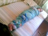 Barefoot girl mummified in a bedsheet snapshot 4