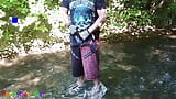 German guy stands in a creek, pisses and jerks off his hard cock snapshot 1