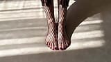 Девушка в черных колготках-чулках-сеточках ласкает ее ноги snapshot 14