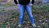 Pissed in jeans in a public park! Mature milf outdoors did not have time to take off her jeans and urinates right in the snapshot 3