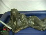 Woman struggling in a green latex bag snapshot 12