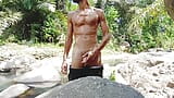 Masturbation by a tropical river and huge and thick cumshot on a stone snapshot 4