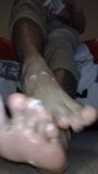 Latino puts white cream on his feet snapshot 8