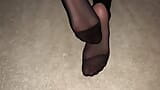 Girl shows her sexy feet in black nylon pantyhose snapshot 10