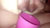 Young mom pours milk from boobs into a cup snapshot 6