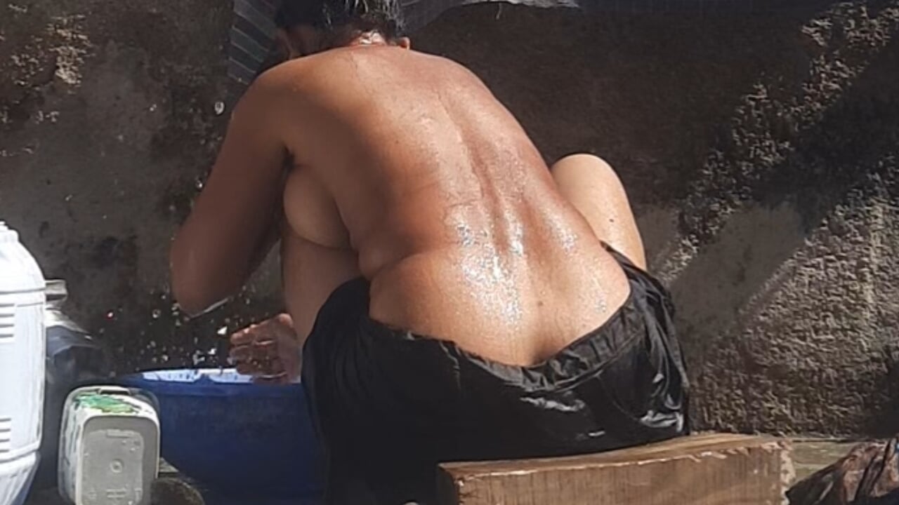Step-sister was seen bathing in the open bathroom of the village.