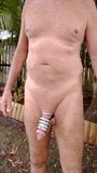 Cock stretching weights naked in the garden. snapshot 1