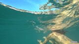 Nude model swims on a public beach in Russia. snapshot 13