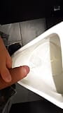 Young boy pissing in public toilet snapshot 2