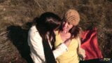 Sharing a gentle kiss outdoors the lesbian couple gets heated and they take out their strapon snapshot 5