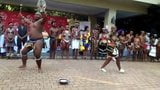 Busty African girl and fat guy doing some sort of show snapshot 2