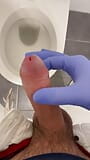 Jerking doctor at a toilet with latex gloves snapshot 2