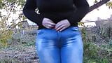 Pissed in jeans in a public park! Mature milf outdoors did not have time to take off her jeans and urinates right in the snapshot 1