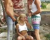 A slim blonde beauty from Germany gets pounded by two hard cocks outdoors snapshot 2