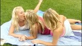 3 pretty blonde girls frolicking on the grass snapshot 2