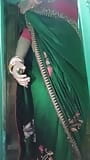 Indian Gay Crossdresser Gaurisissy in Green Saree Pressing Her Big Boobs and Fingering in Her Ass snapshot 2