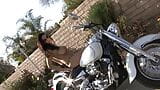 Gorgeous brunette babe fucks her juicy cunt with her favorite sex toy on a motorbike snapshot 3