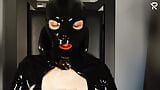 Rubberslut with Heavy Rubber Helmet fucking her pussy on slave chair snapshot 3