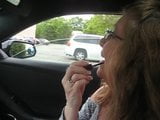 Pretty Grandma smokes in the car snapshot 2