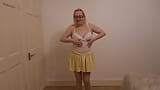 Dancing striptease in yellow miniskirt and pantyhose snapshot 3