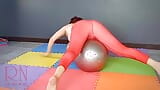 Regina Noir. a Woman in Yoga Leotards Practices Yoga in the Gym. Transparent Red Leotard Yoga. Full Video snapshot 10