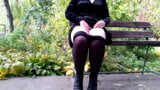 Peeing with legs spread wide on a bench in an autumn park snapshot 6