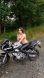 Pretty young sexy girl is riding her motorcycle - Desire shows her asshole and pees beside the country road near forest snapshot 2