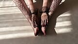 Girl in black fishnet pantyhose caresses her legs snapshot 13